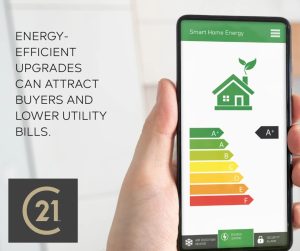 A hand holding a smartphone displaying a Smart Home Energy app with an A+ efficiency rating and a Century 21 logo